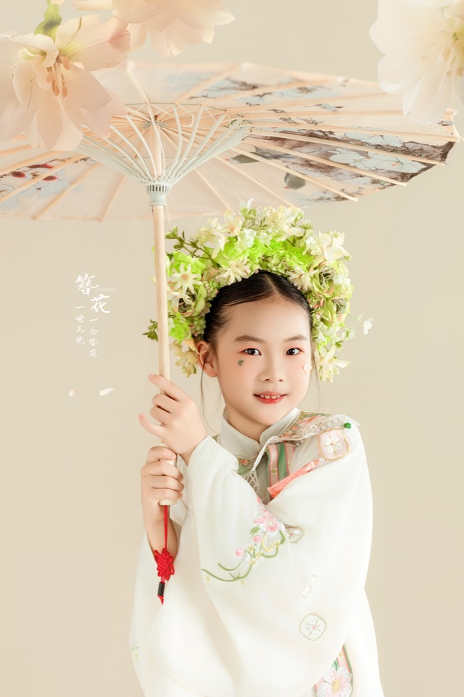 郭梦昕戴着花环，在花伞下微笑